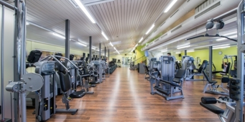 Blick in das moderne und helle Fitnessstudio im Sporthotel in der Schweiz 
