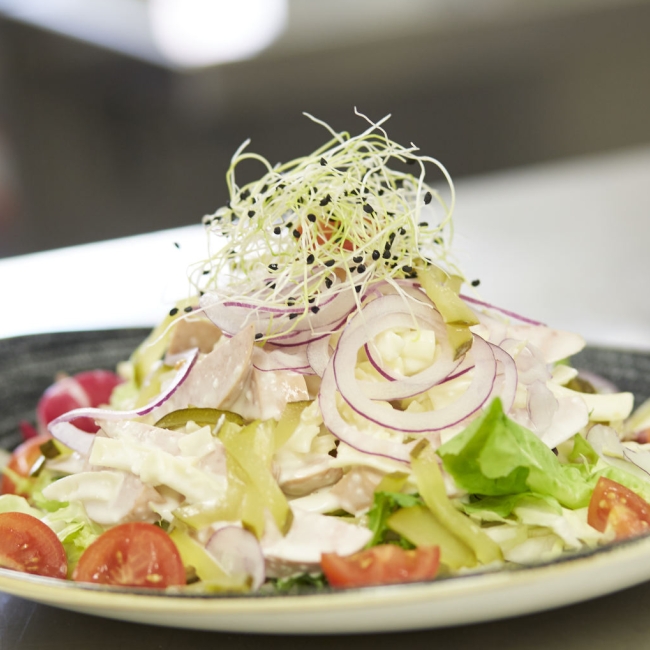 Wurst Käse Salat auf einem stilvoll angerichteten Teller