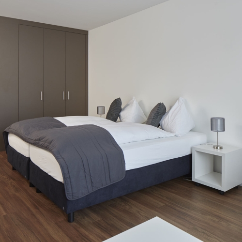 Modern box spring bed in a room of the apart hotel near zurich