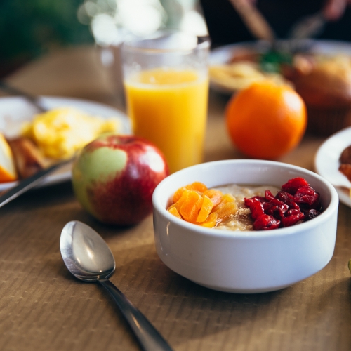 Breakfast table in the apart hotel near zurich with fruit, juice and pastries 
