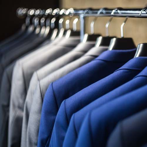 Stylish men's suits on a clothes rail in the apart hotel near zurich